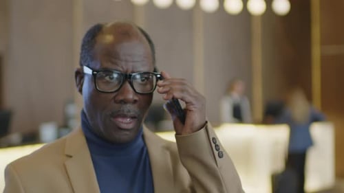 African American Businessman Making Phone Call in Hotel Lobby