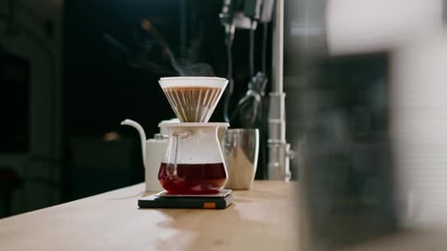 Coffee Brewing in Glass Carafe on Wooden Counter