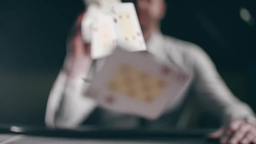 Man Tossing Poker Cards in Slow Motion