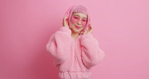 Smiling Woman in Pink Dancing with Headphones