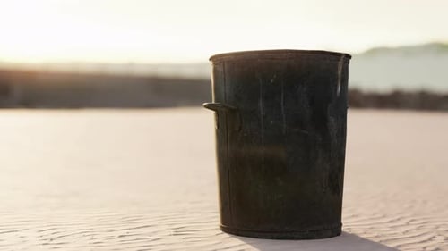 Gray Metal Garbage Bin or Trash Can on the Beach