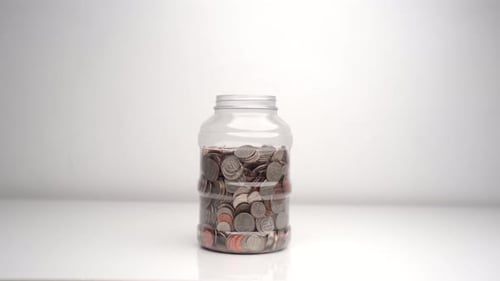 Dropping Coin In Piggy Bank