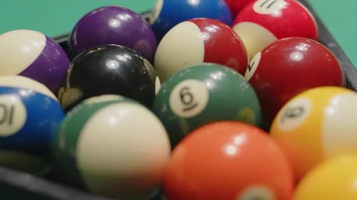 Fifteen Colorful Billiard Balls with Numbers Racked in Pyramid for Pool