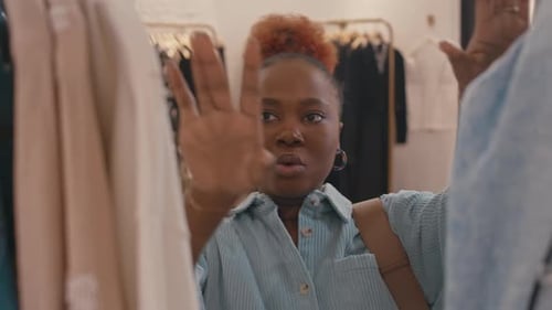 Young Black Woman Shopping for Clothes in Designer Showroom