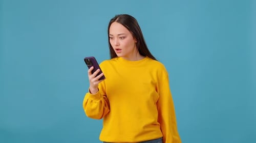 Woman Excited About Phone While Holding Cash