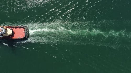 Tug Boat in Open Calm Sea Helps Large Container Ships Maneuver Aerial Top Down View Maritime