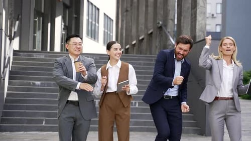Happy Colleagues Celebrate Business Success with Cheerful Dance