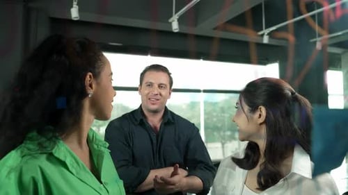 Coworkers Chatting in Modern Office Collaboration