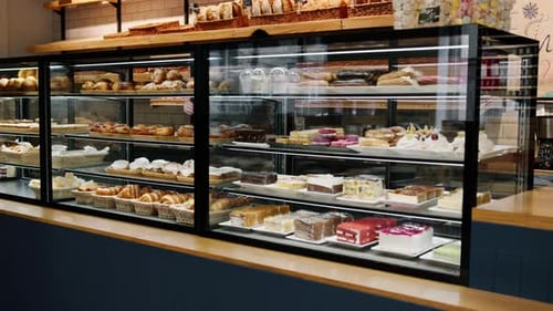 Counter full of delicious buns and pastries in a shop, bakery
