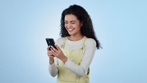 Woman, laugh and typing with phone in studio to update social media post