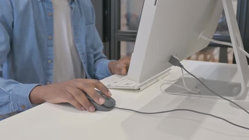 Close up of African Male Hand Using Computer Mouse for Work