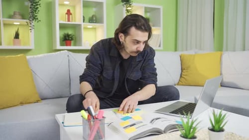 Young Adult Working at Home on Laptop