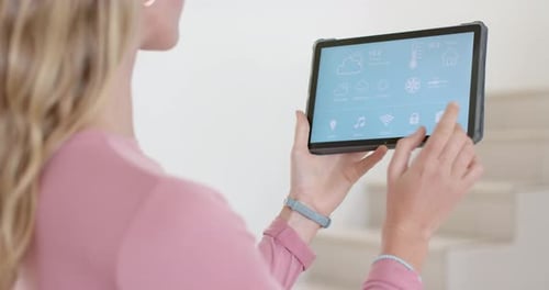Woman Using Smart Home Tablet Interface in Modern Interior