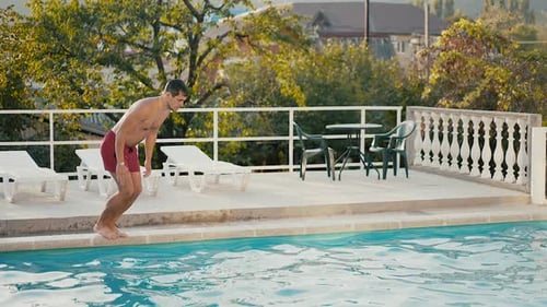 A Man Dives Into a Pool
