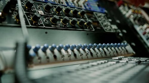 Sound engineer using digital audio mixer sliders Engineer pressing keys adds control panel volume