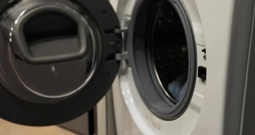 Hand Opens Washing Machine, Adds Laundry Pod