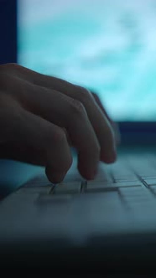 Hände, die eine Tastatur mit einem Computerbildschirm im Hintergrund für verschiedene Aufgaben und Aktivitäten verwenden