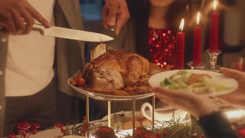 Closeup Shot of African American Man Cutting Turkey on Christmas