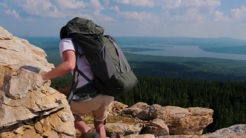 Young Woman and Man Walking Down the Mountain