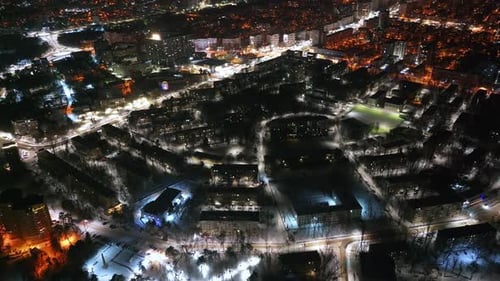 Aerial drone view of Chisinau city covered in snow at night, blue hour. Moldova