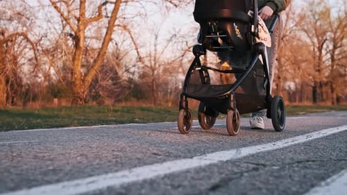 Low Angle Tracking Shot Stroller Wheels And Mother Feet Walking