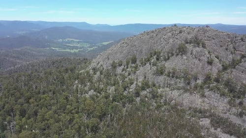 Aerial flight approaches unique rocky Sugarloaf mountain in Victoria