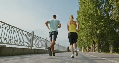 Fitness Woman Drinking Water From Bottle After Running Exercise in City Park