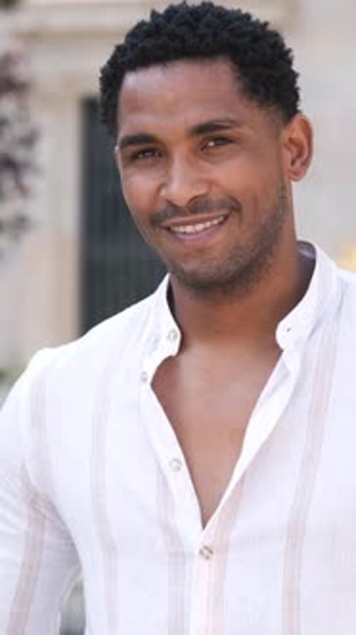 Happy Young Man Smiling While Looking at Camera in City During Daytime