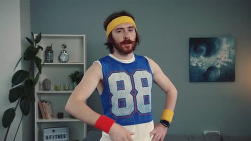 A Sporty Individual Dressed in Retro Athletic Wear While Enjoying Their Time at Home
