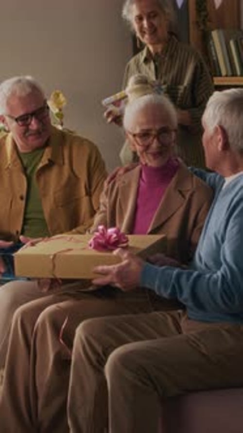 Group of Seniors Celebrating a Birthday with Gifts