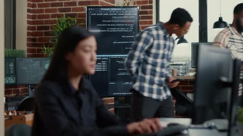 Softwareentwickler vergleicht Codefehler auf dem Wanddisplay mit dem Tablet