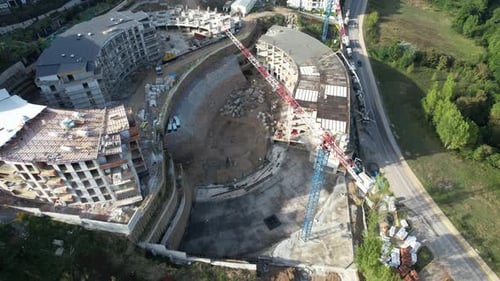 Aerial View of Curved Buildings Under Construction