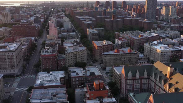 Aerial footage pans down on Harlem rooftops in NYC. Gorgeous golden ...