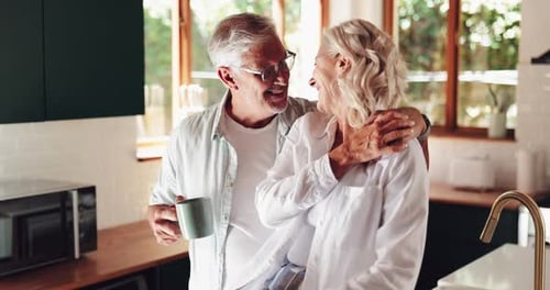 Loving Mature Couple Embracing in Kitchen