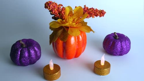 Colorful Pumpkins and Candle Arrangement on White Surface