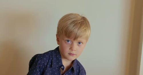 Young Boy Smiling Indoors in Close Up Shot