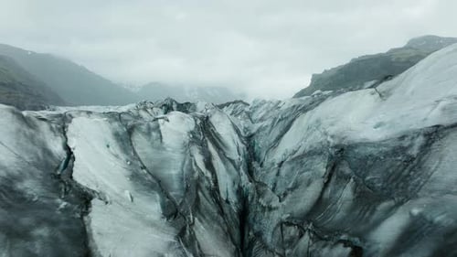 Aerial drone footage of Svínafellsjökull Glacier in Iceland, showcasing its stunning ice formations.