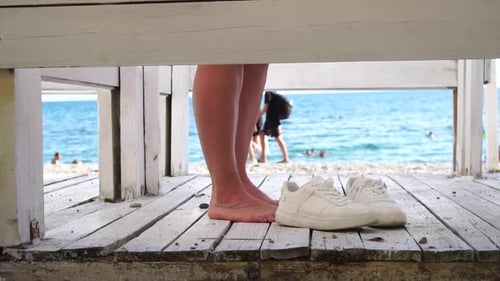 Woman in the Changing Dressing Room on the Beach at Sunset on the Seashore The Girl Changes Clothes Woman in the Changing Dressing Room on the Beach at Sunset on the Seashore The Girl Changes Clothes
