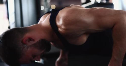 Man Doing Slow Push Ups at the Gym