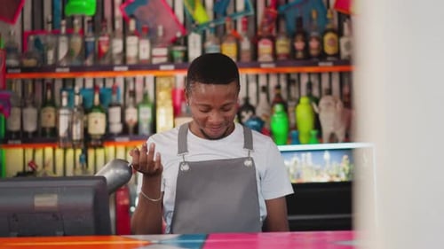 Smiling Bartender with scoop at a Colorful Bar