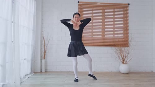 Young Woman Dances Ballet in Bright Studio