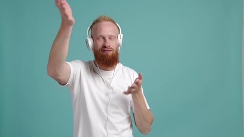 Man Dancing with Headphones on Blue Background