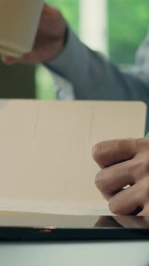 Unknown Business Man Drinking Coffee Cup Writing Notes Write in Copybook Notebook Cropped View