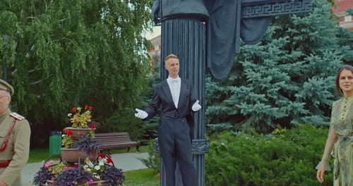 People in Historical Costumes Standing in an Urban Park