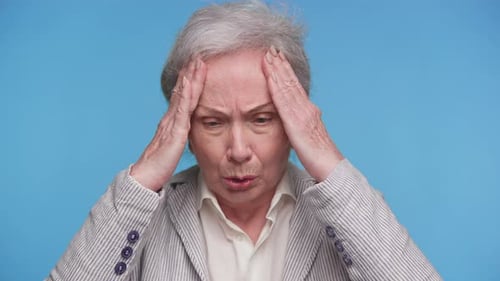 Senior Woman Experiencing Headache Touching Temples Close Up