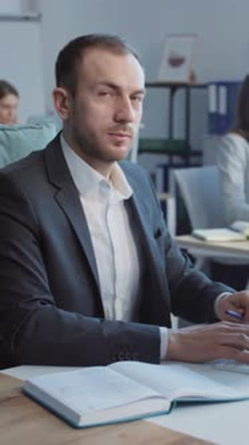 Man in Suit Working in Office and Smiling