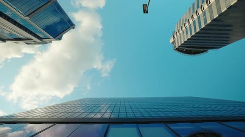 Contemporary Office Buildings with Mirror Glass Facades Under Blue Sky Low Angle View