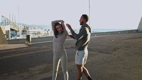 Personal Trainer Guiding Woman in Stretching Exercises Outdoors