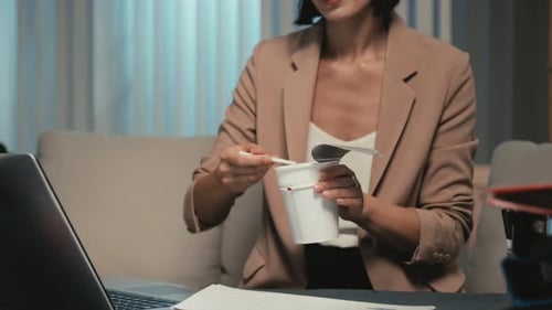 Busy Entrepreneur Having Dinner with Noodles at Office