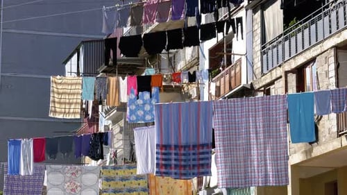 Drying Clothes on a Clothesline Between Houses in a Poor Area of the City